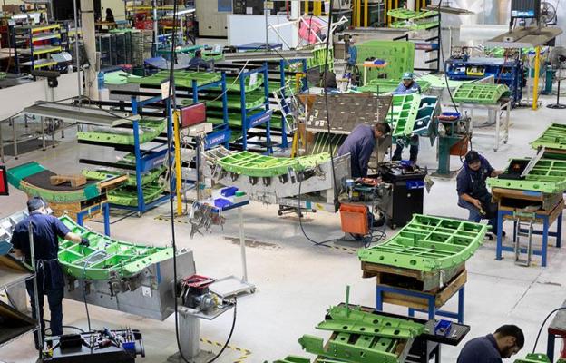 Overhead shot of factory floor with workers assembling doors