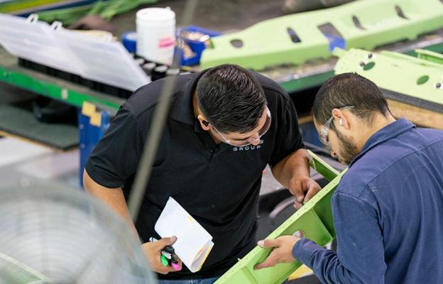 Two men inspecting a part