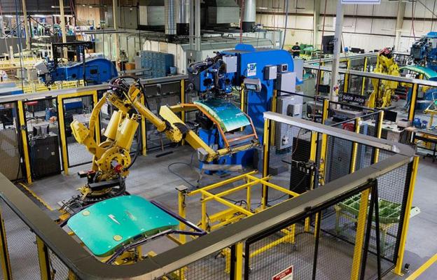 Overhead shot of a factory with machines assembling doors