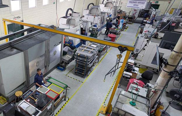 Overhead view of factory floor with people and machines
