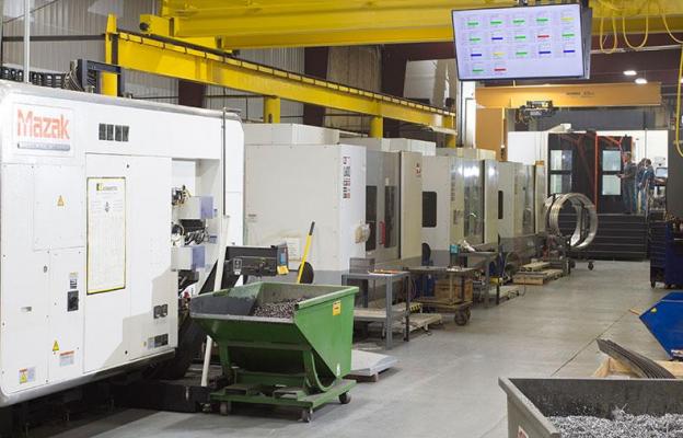 Corridor with large machines and carts holding metal chips