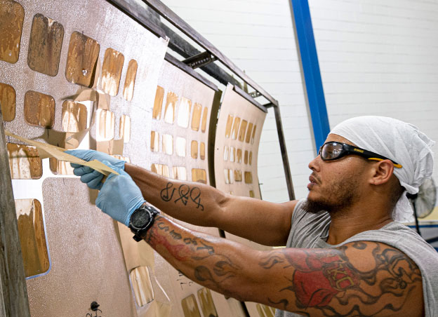 man working next to chemical milling machine