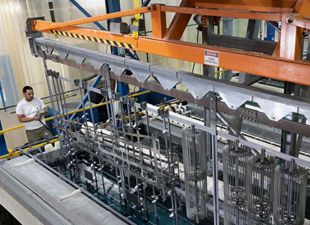 Man operating phosphoric acid anodizing line