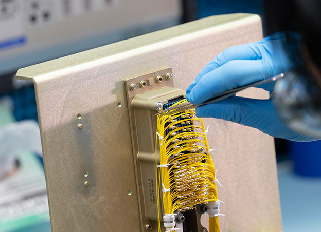 Close up of hand manipulating electronic assembly