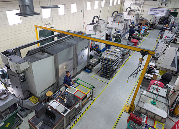 Overhead view of factory floor with rows of CNC machines