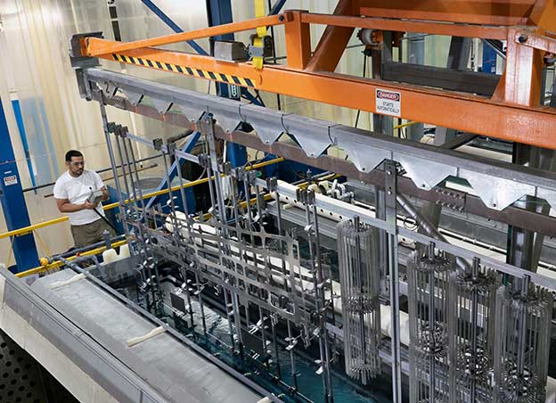 Man operating phosphoric acid anodizing line