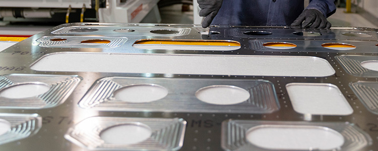 Person operating a mold for sheet metal