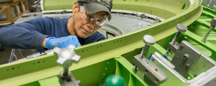 Man working on interior of bulkhead assembly